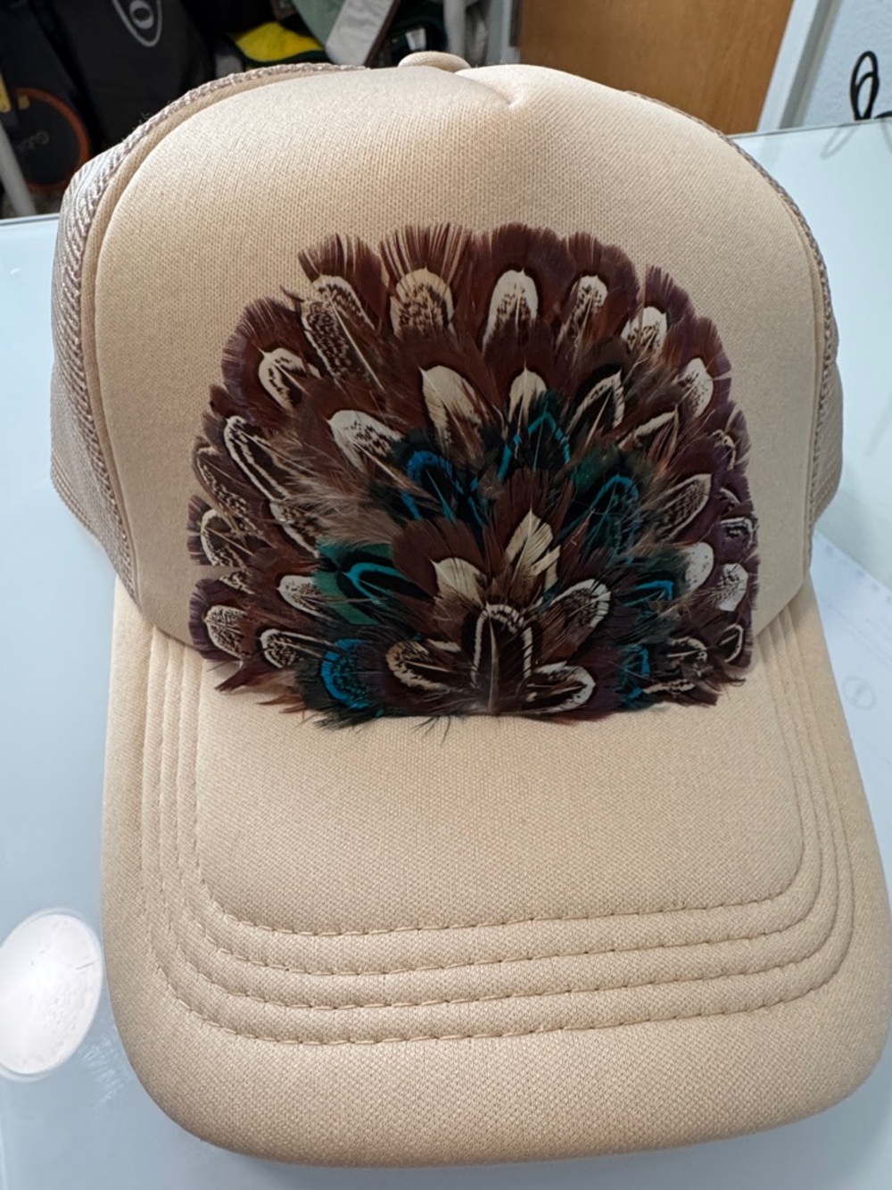 Beige Trucker Hat with Decorative Feather Accent
